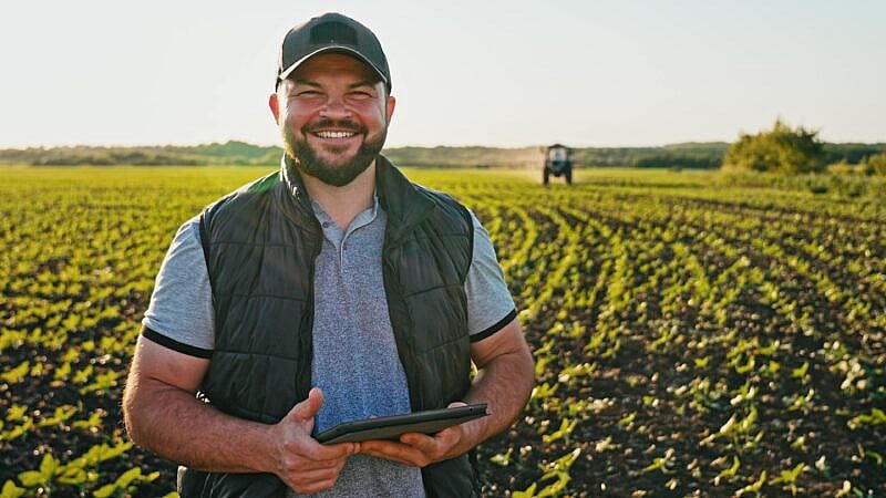 Happy,Farmer,Stands,And,Smile,Holds,Tablet,In,His,Hands