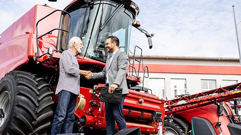 Farmer,And,Dealer,Shaking,Hands,After,Successful,Tractor,Purchase.,Investing