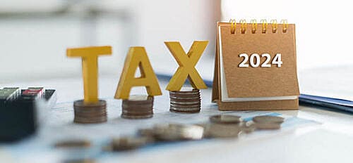 Tax golden wooden text and the number 2024 on the calendar. Pay tax in 2024 years. The new year 2024 tax concept.